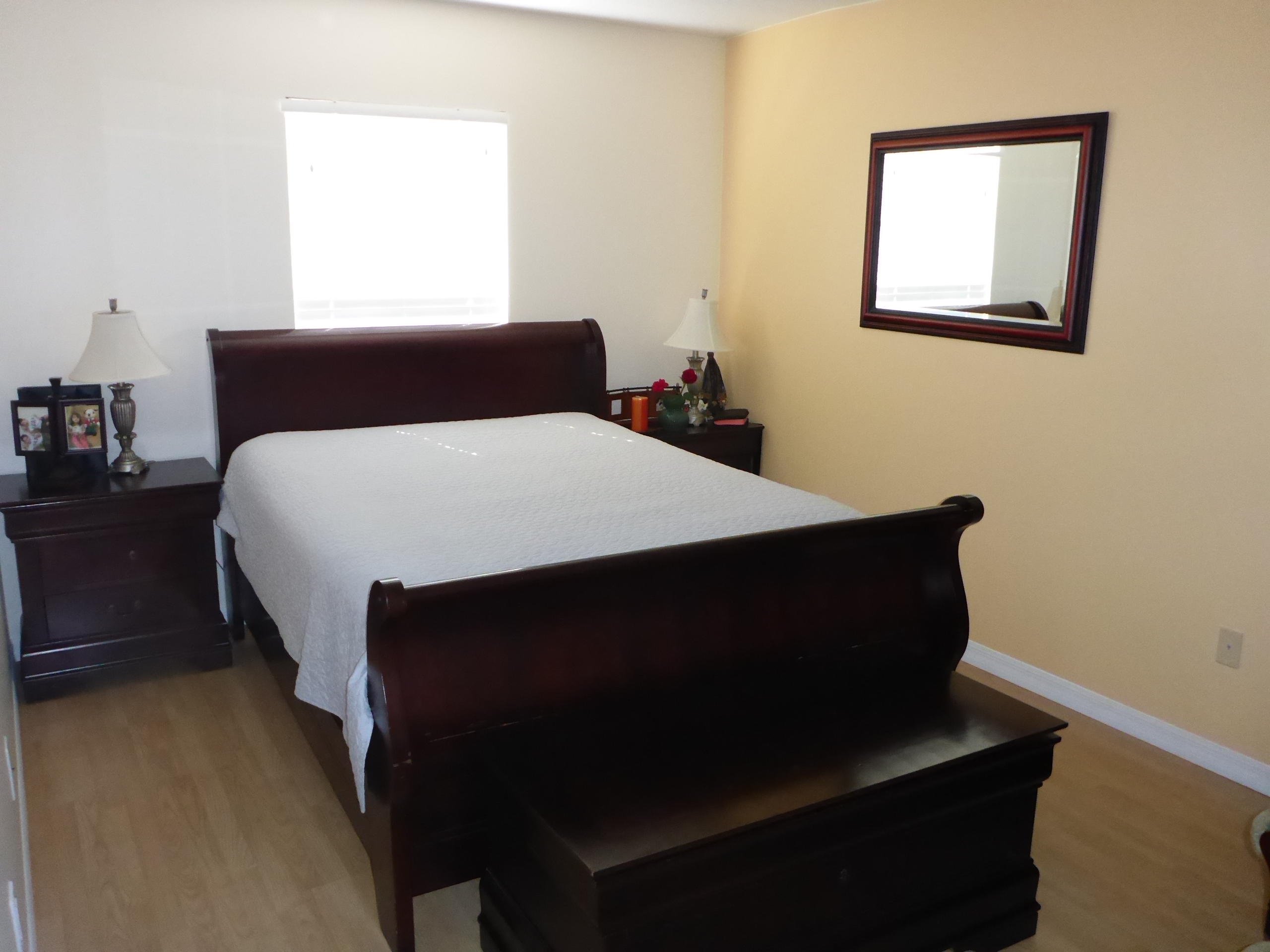 5124 Elpine Way Riviera Beach, FL 33418 - Photo 37 of 45 a bed sitting in a bedroom next to a window