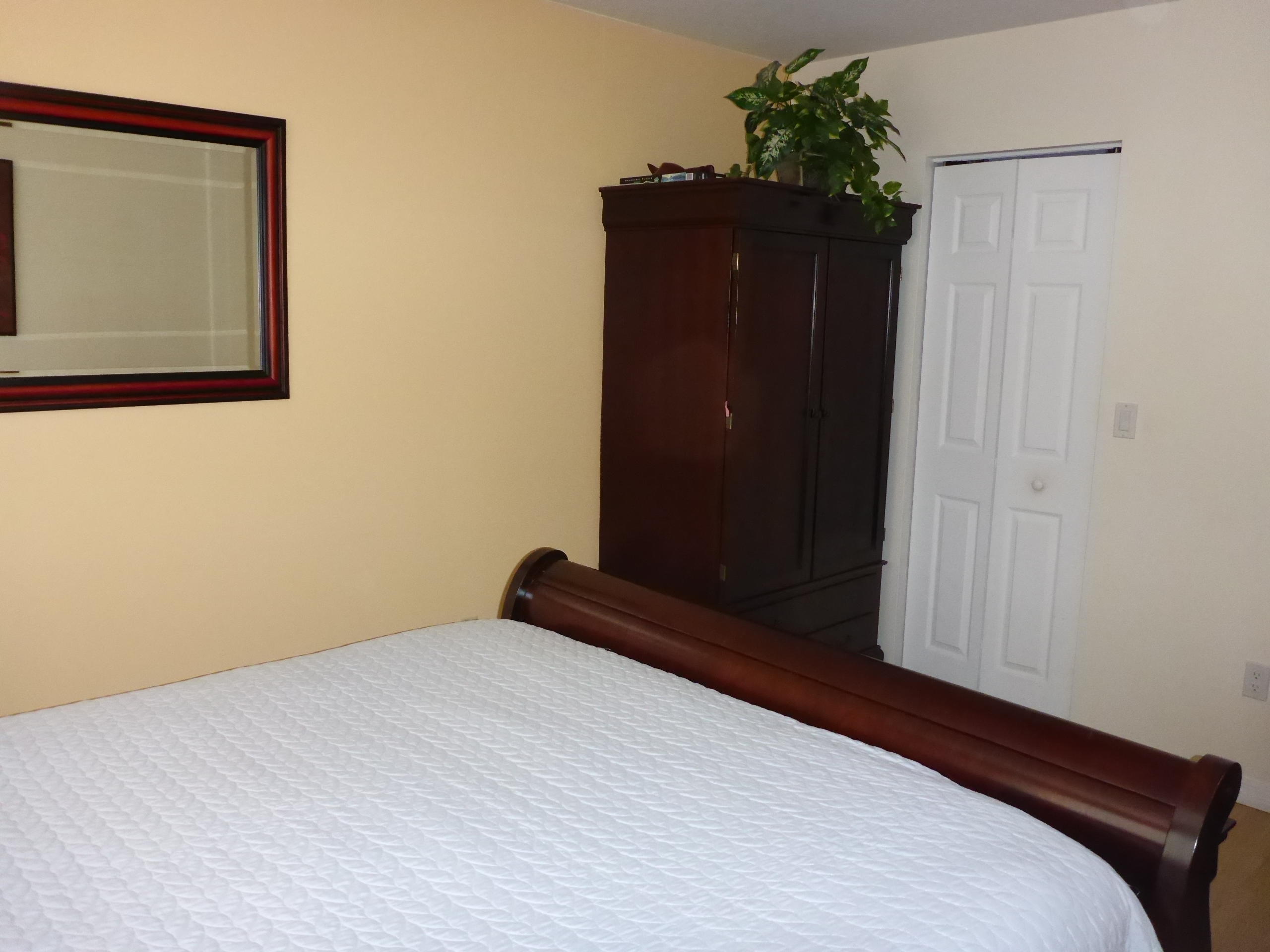 5124 Elpine Way Riviera Beach, FL 33418 - Photo 38 of 45 a bedroom with a bed and a dresser