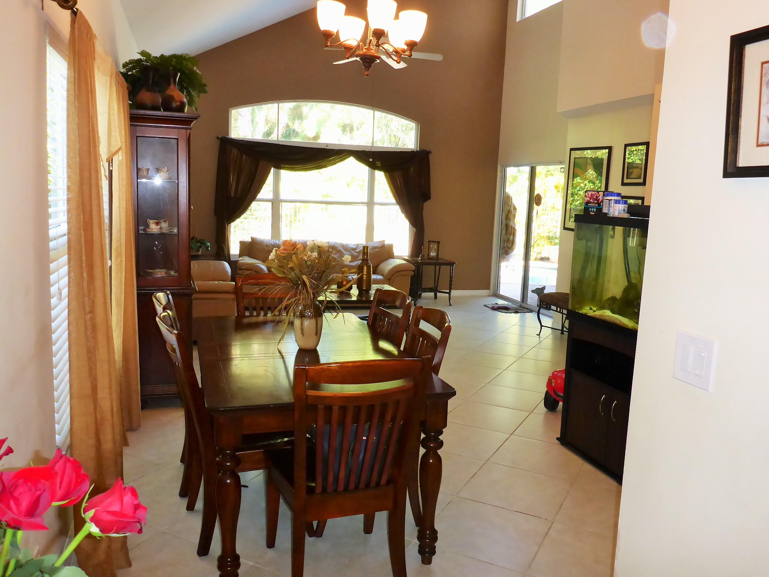 5124 Elpine Way Riviera Beach, FL 33418 - Photo 4 of 45 a view of a dining room with furniture and a chandelier