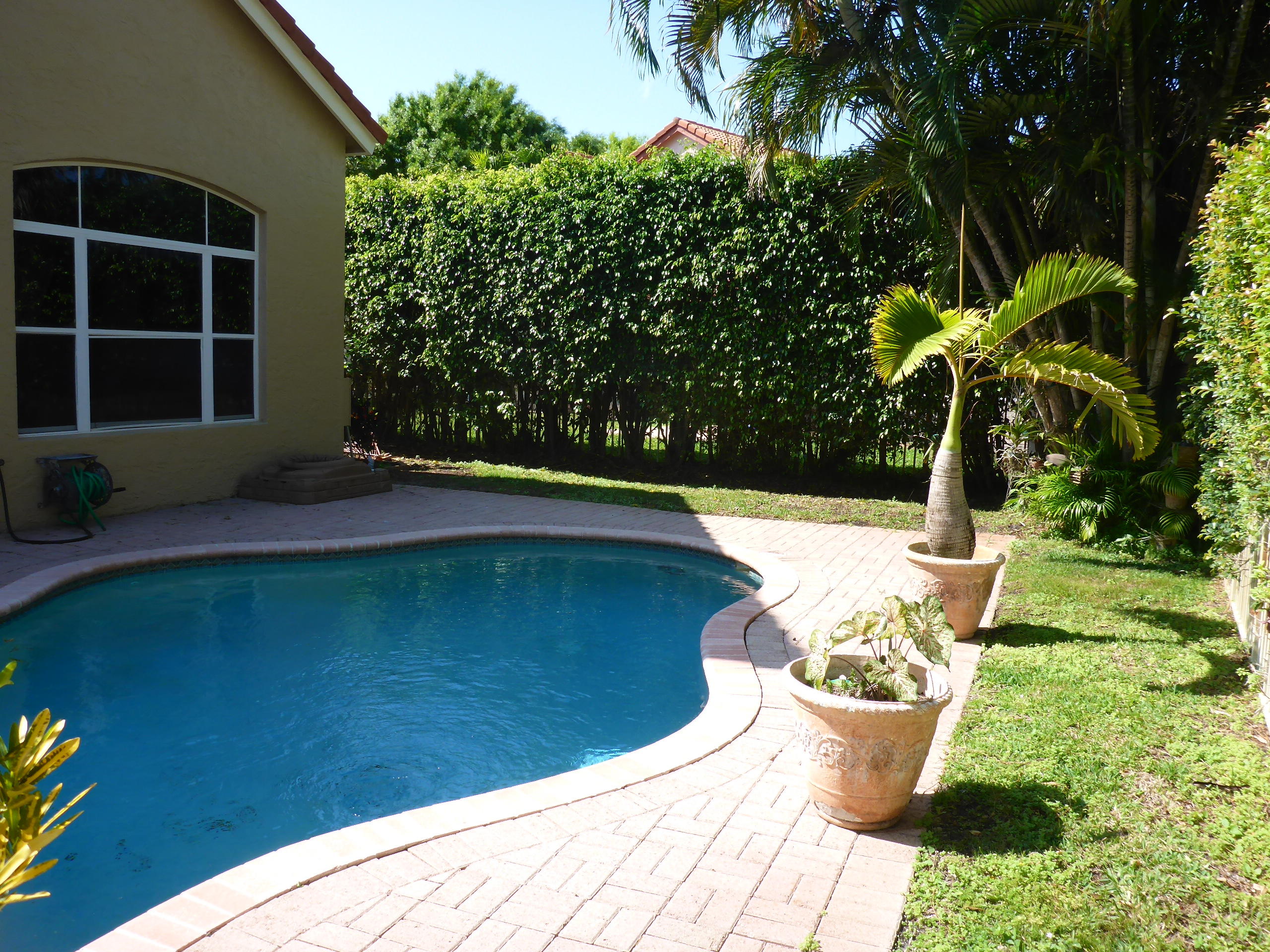 5124 Elpine Way Riviera Beach, FL 33418 - Photo 42 of 45 a view of a swimming pool with a patio