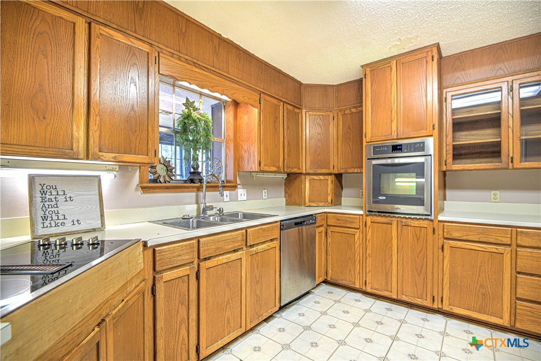 305 Tanglewood Road Temple, TX 76502 - Photo 11 of 46 a kitchen with stainless steel appliances a sink window and cabinets
