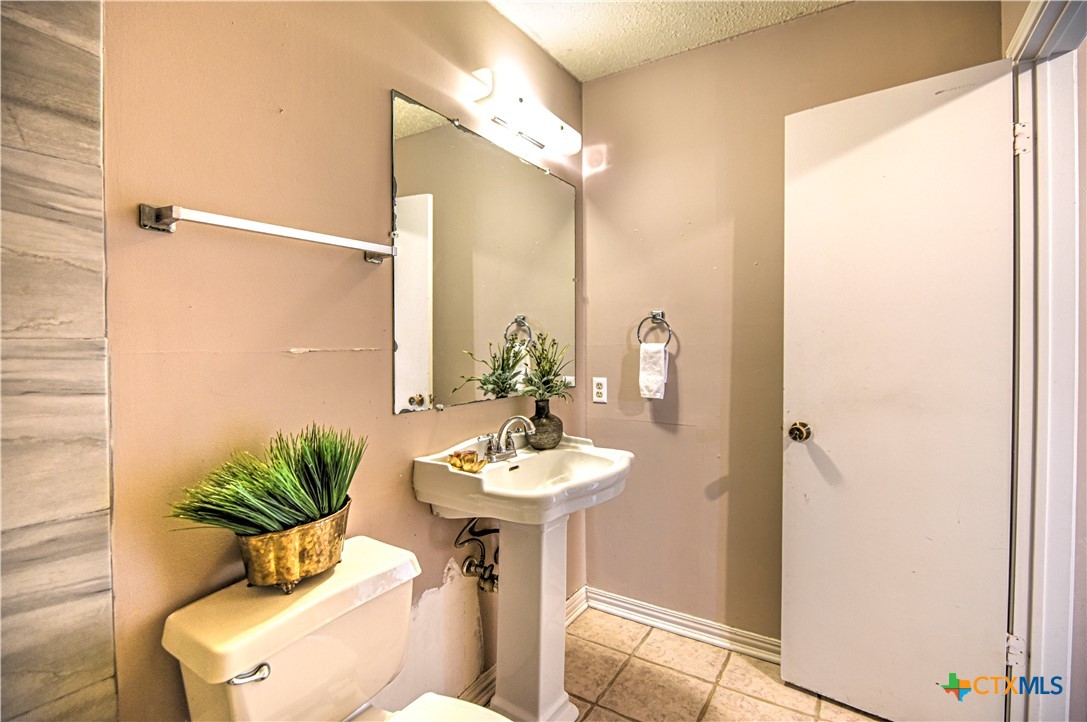 305 Tanglewood Road Temple, TX 76502 - Photo 24 of 46 a bathroom with a sink and a mirror