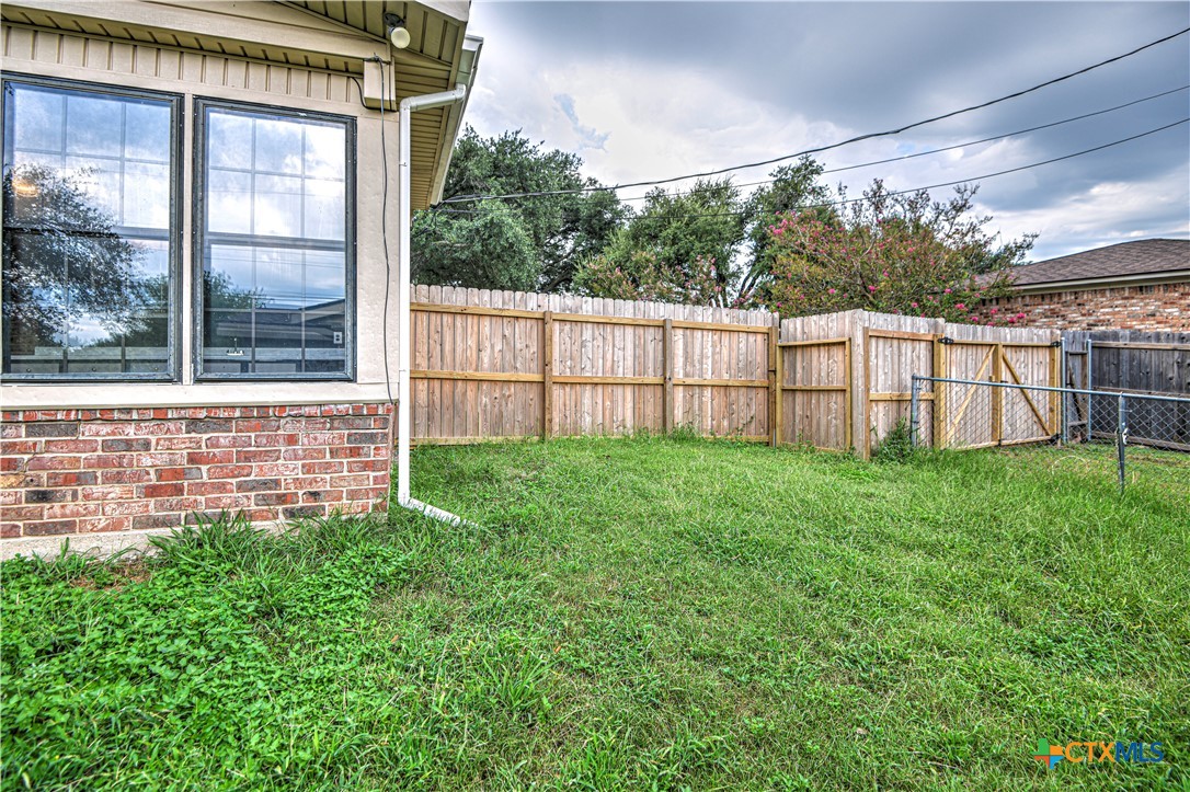 305 Tanglewood Road Temple, TX 76502 - Photo 26 of 46 a view of a house with a small yard and wooden fence