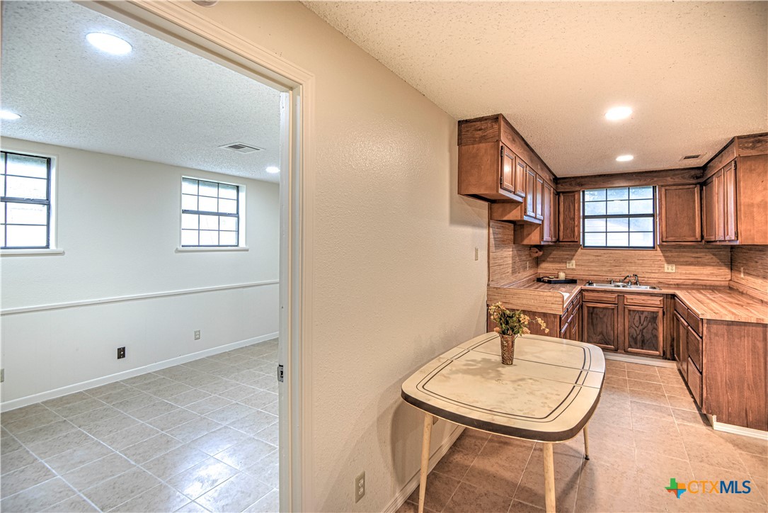 305 Tanglewood Road Temple, TX 76502 - Photo 36 of 46 a living room with furniture and a kitchen