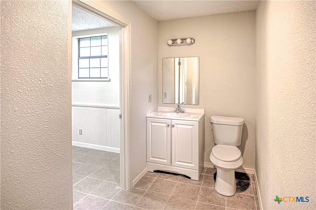 305 Tanglewood Road Temple, TX 76502 - Photo 39 of 46 a white toilet sitting next to a bathroom sink
