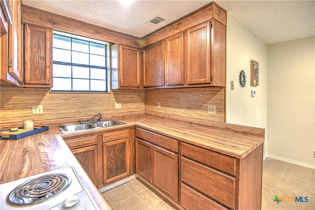 305 Tanglewood Road Temple, TX 76502 - Photo 41 of 46 a kitchen with stainless steel appliances granite countertop a sink and a cabinets