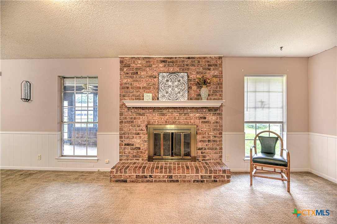 305 Tanglewood Road Temple, TX 76502 - Photo 9 of 46 a living room with furniture and a fireplace