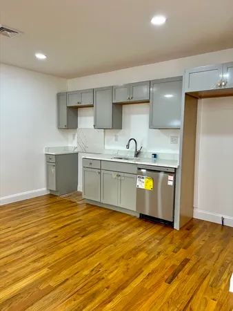 a kitchen with stainless steel appliances granite countertop a sink and cabinets