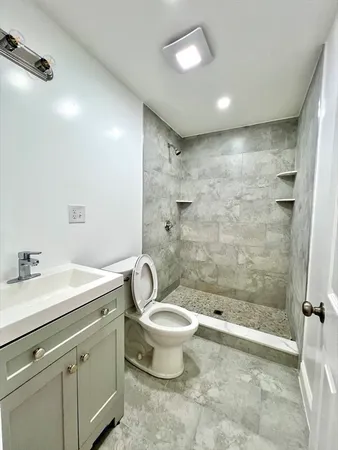 a bathroom with a sink toilet and shower