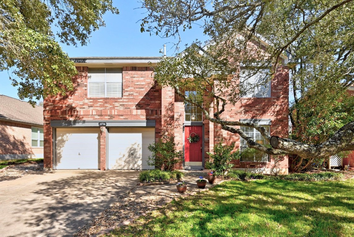 a front view of house with a garden