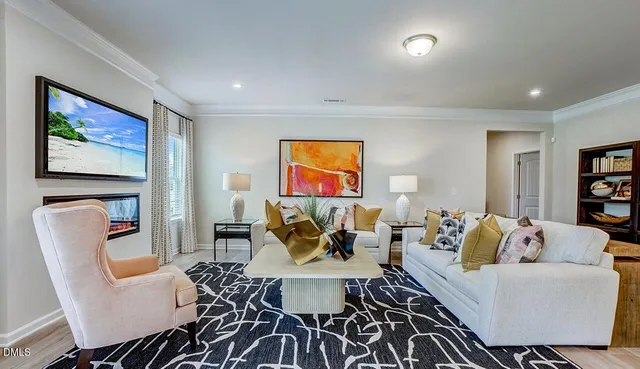 a living room with furniture a rug and a painting