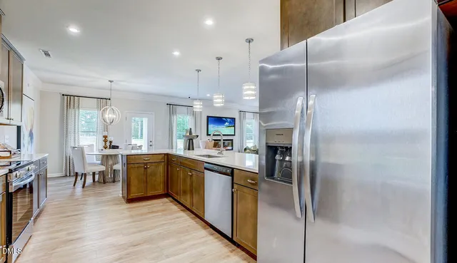 a large kitchen with stainless steel appliances lots of counter top space