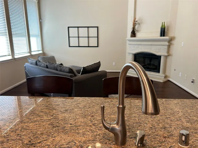 a kitchen with granite countertop stainless steel appliances a sink dishwasher microwave stove and cabinets