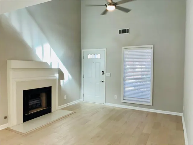 a view of an empty room with a fireplace