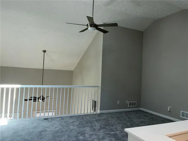 a view of a hallway with a ceiling fan