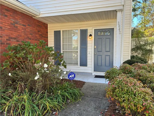 a view of a house with potted plants