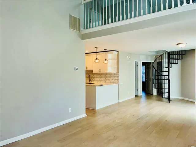 a view of an empty room with closet and a window