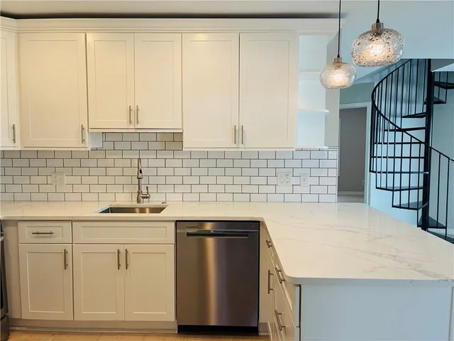 a kitchen with a sink cabinets and appliances