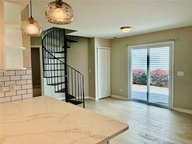 a view of an entryway with wooden floor