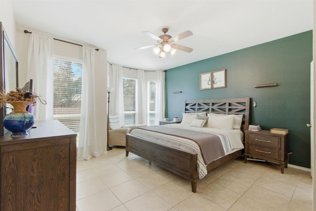 6625 Hayling Way Denton, TX 76210 - Photo 14 of 33 a bedroom with a bed and a chandelier