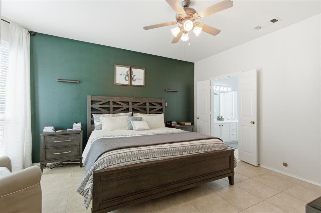 6625 Hayling Way Denton, TX 76210 - Photo 16 of 33 a bedroom with a bed and a chandelier