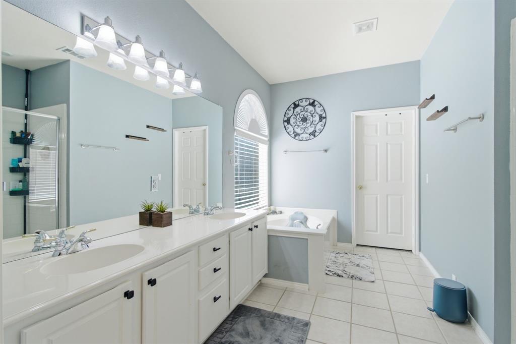 6625 Hayling Way Denton, TX 76210 - Photo 17 of 33 a bathroom with a double vanity sink mirror and bathtub