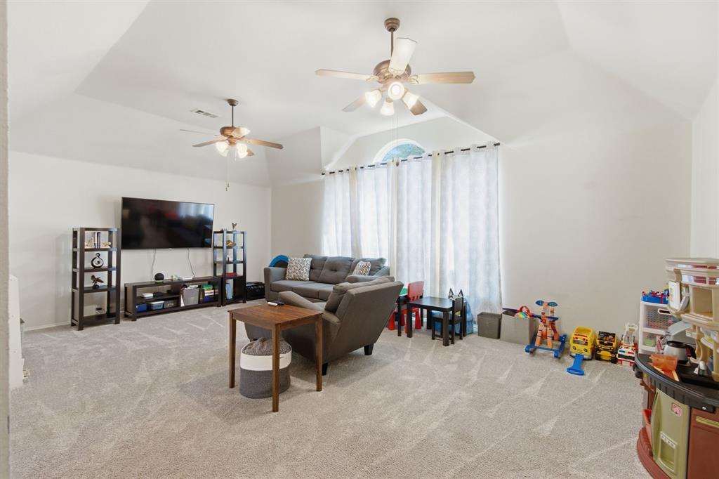 6625 Hayling Way Denton, TX 76210 - Photo 19 of 33 a living room with furniture and a flat screen tv