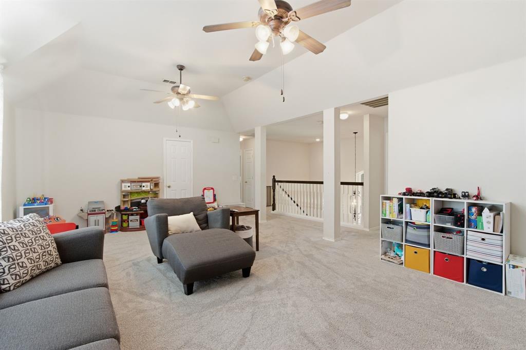 6625 Hayling Way Denton, TX 76210 - Photo 21 of 33 a living room with furniture and a book shelf