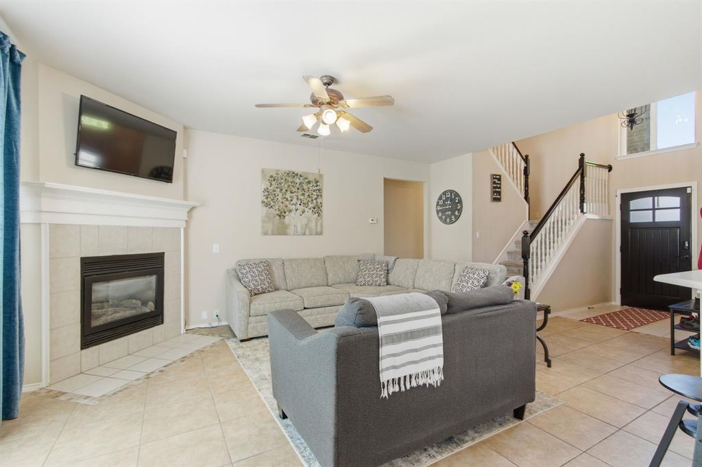 6625 Hayling Way Denton, TX 76210 - Photo 7 of 33 a living room with furniture a fireplace and a flat screen tv
