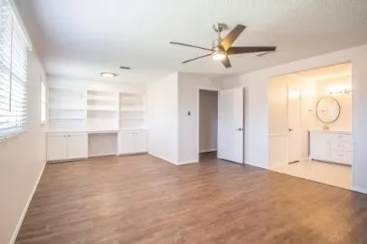 a view of a livingroom with a ceiling fan and window