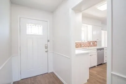 a view of bathroom with a sink mirror and window