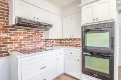 a kitchen with granite countertop cabinets stainless steel appliances and a sink
