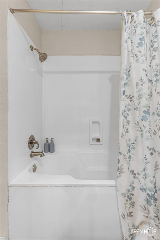 3316 Kessler Boulevard Wichita Falls, TX 76309 - Photo 16 of 35 White bathtub and shower combination with a bronze-finish showerhead and faucet