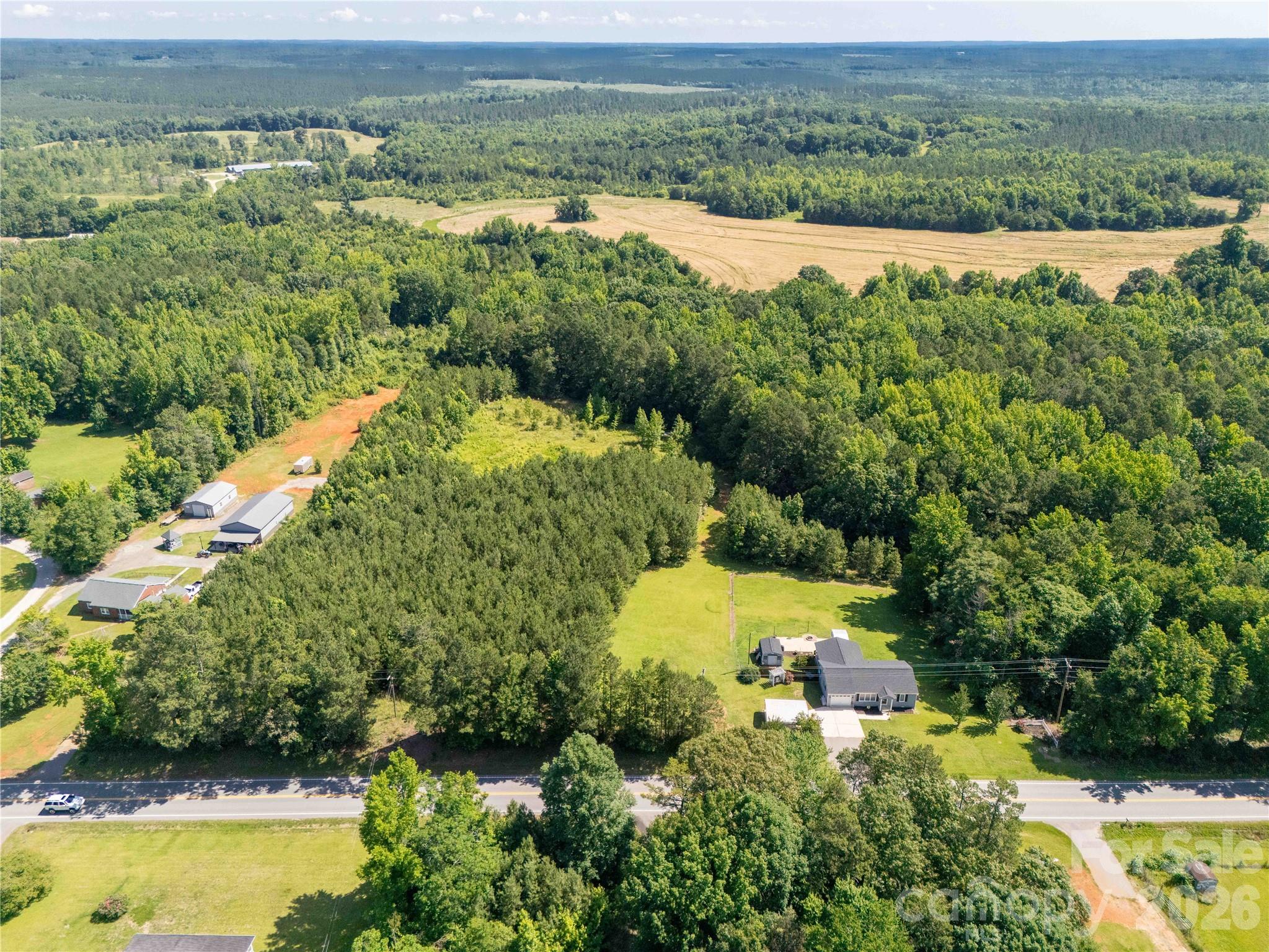 12.85-acres 12.85-acres Flat Creek Road Heath Springs, SC 29058 - Photo 4 of 7 an aerial view of green landscape with trees houses and mountain view
