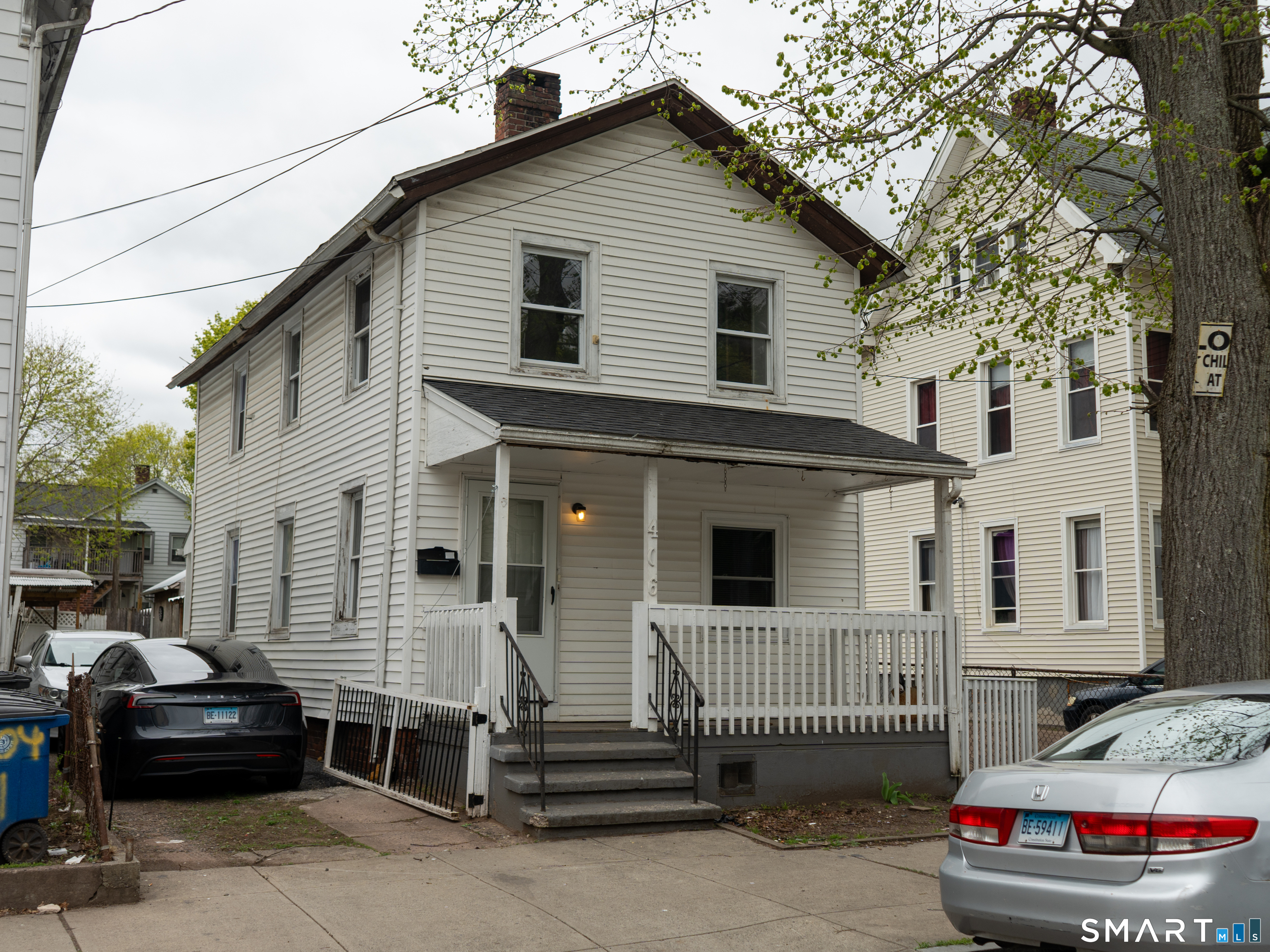 406 Poplar Street New Haven, CT 06513 - Photo 1 of 22 a view of a house with a parking space and a car parked beside it