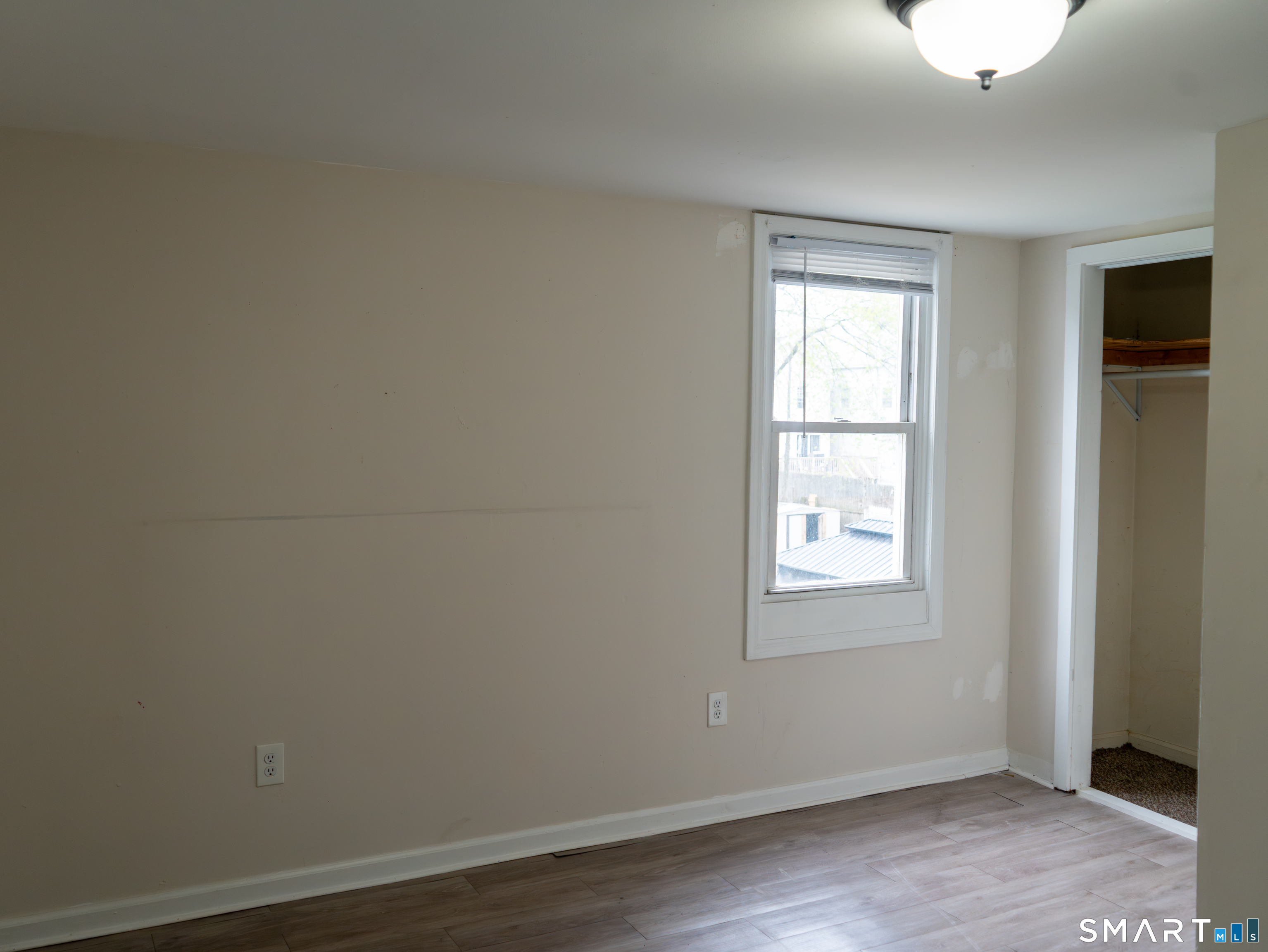 406 Poplar Street New Haven, CT 06513 - Photo 17 of 22 an empty room with wooden floor and windows