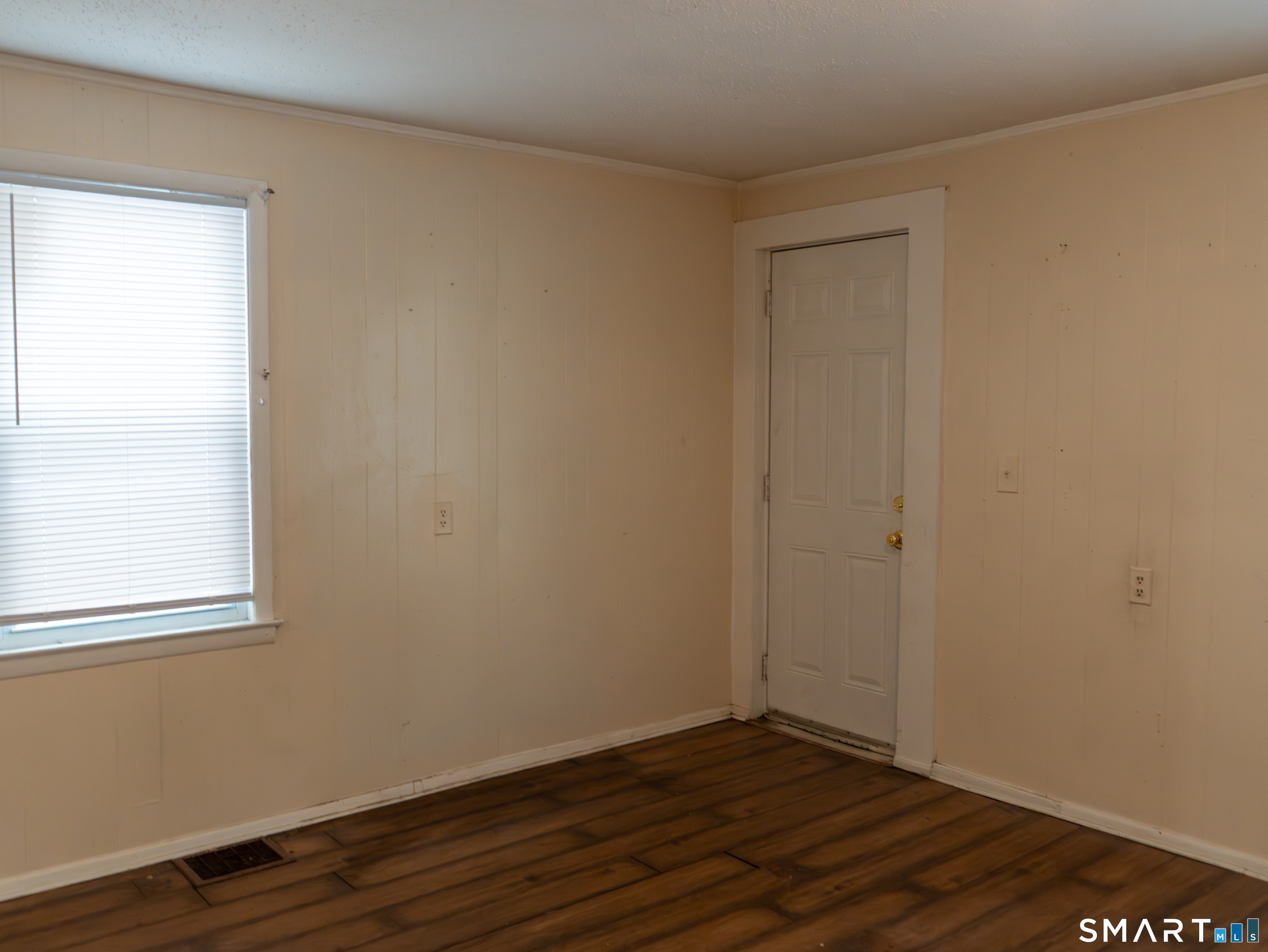 406 Poplar Street New Haven, CT 06513 - Photo 6 of 22 a view of an empty room with wooden floor and a window