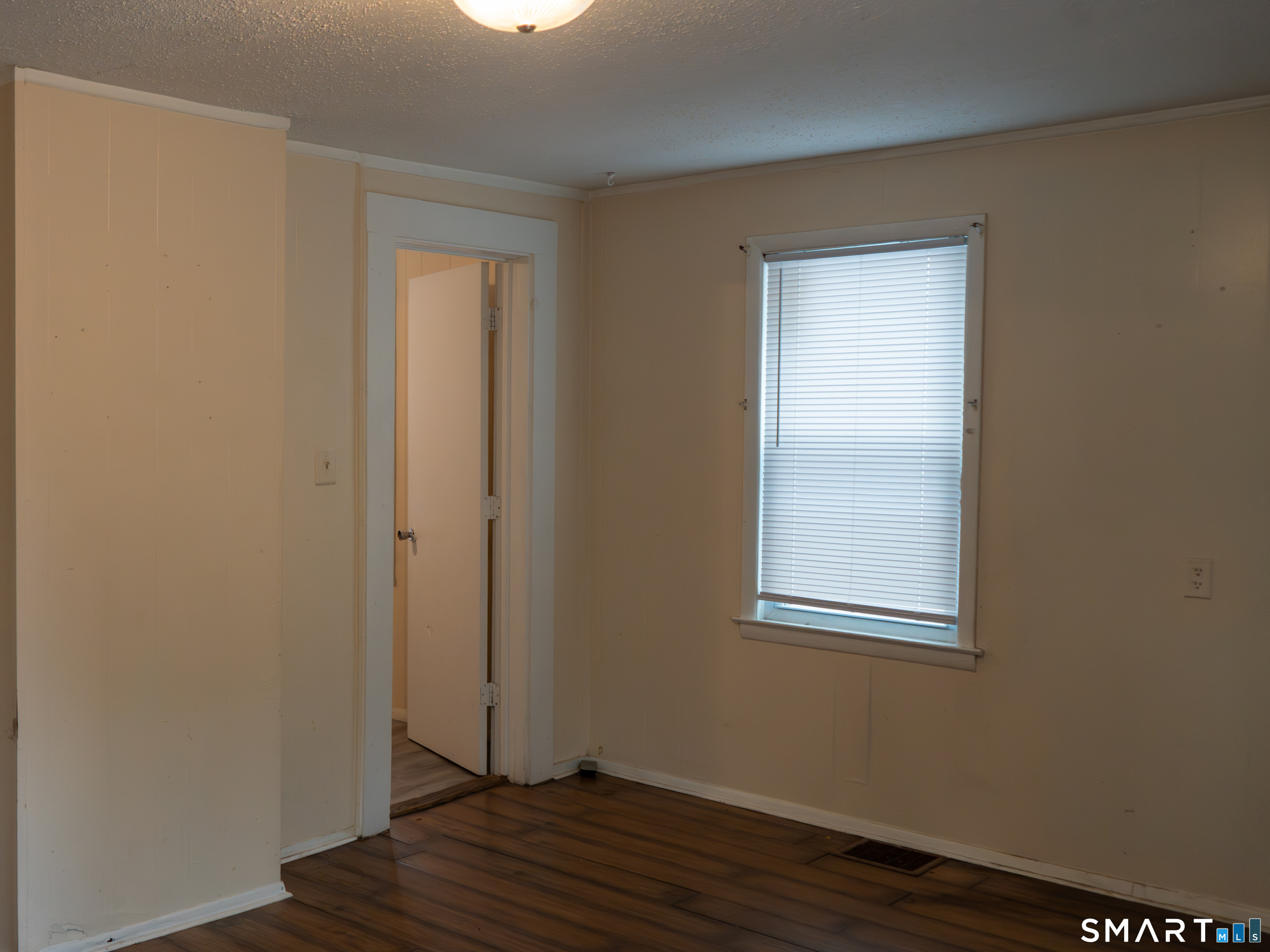406 Poplar Street New Haven, CT 06513 - Photo 7 of 22 a view of an empty room with wooden floor and a window