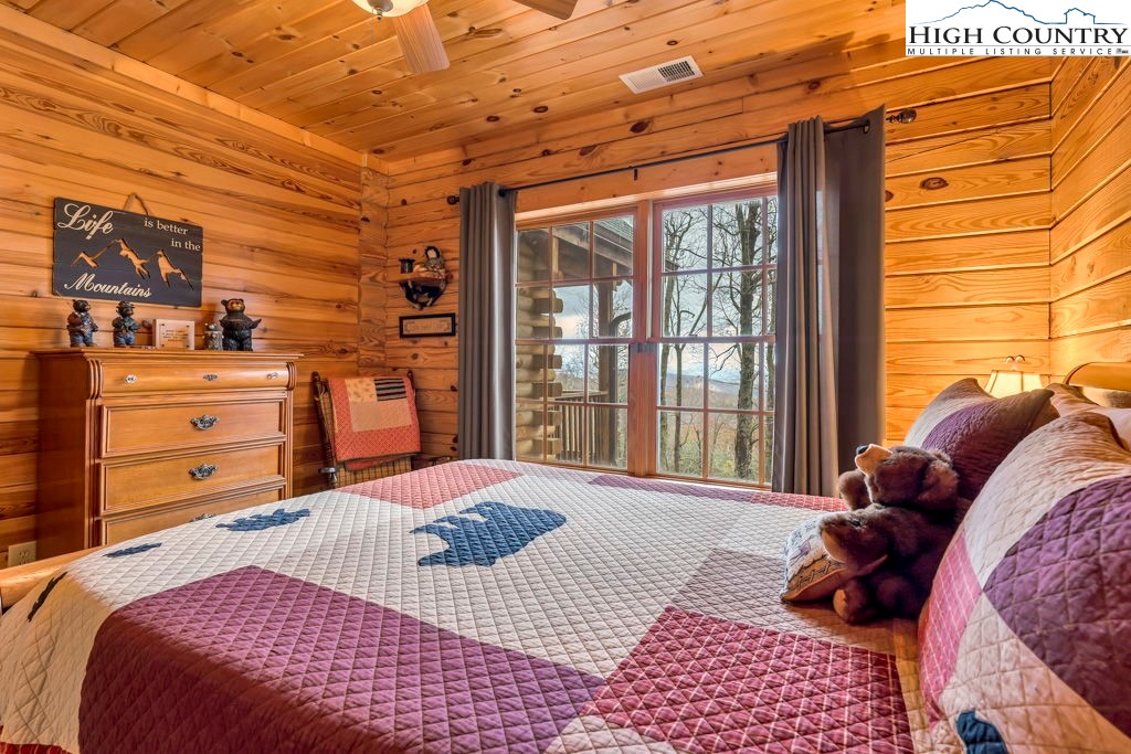 3043 Junaluska Road Boone, NC 28607 - Photo 25 of 49 a bedroom with a bed and wooden floor