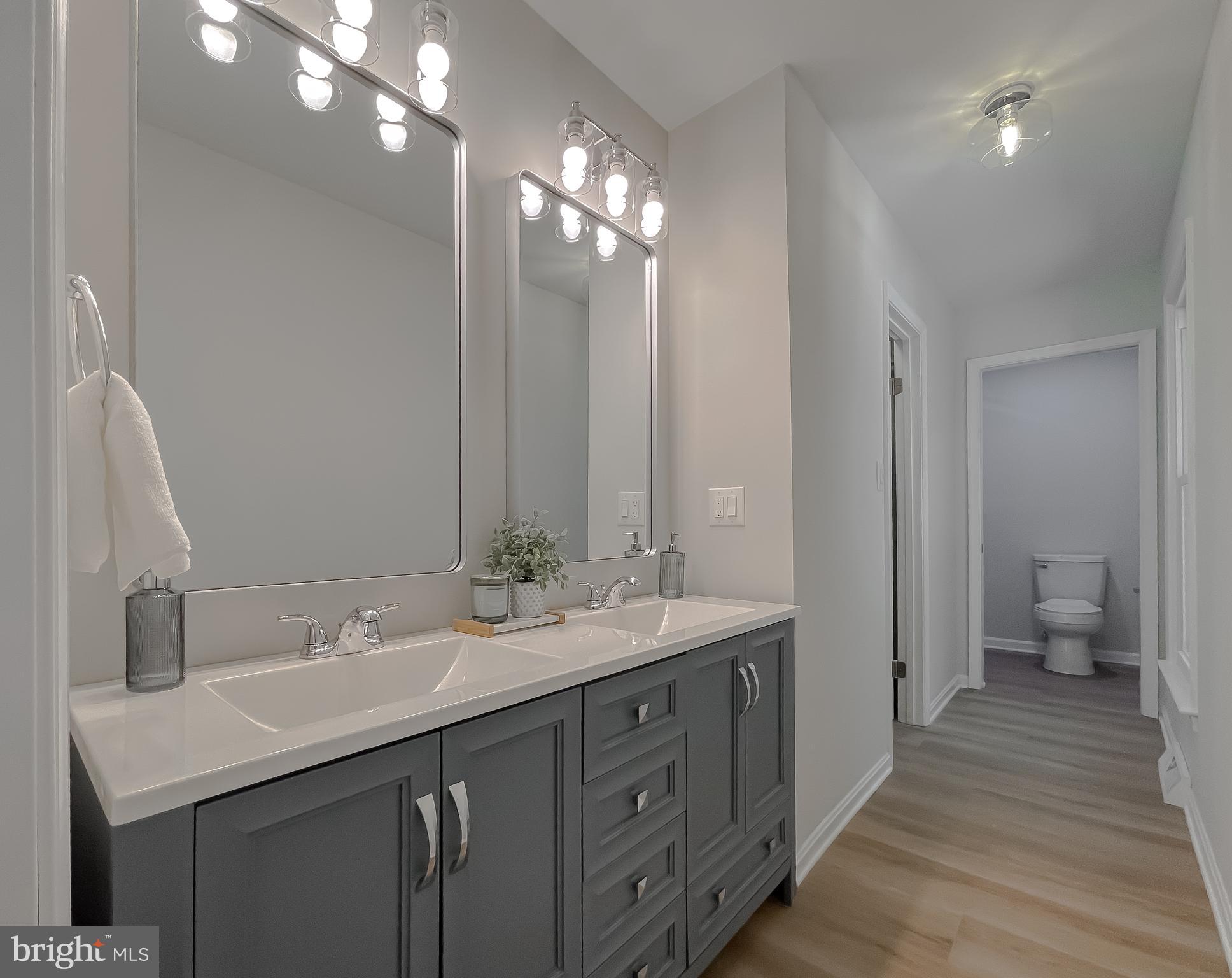 22373 Enoch Road Leonardtown, MD 20650 - Photo 42 of 74 a bathroom with a sink double vanity granite and a mirror