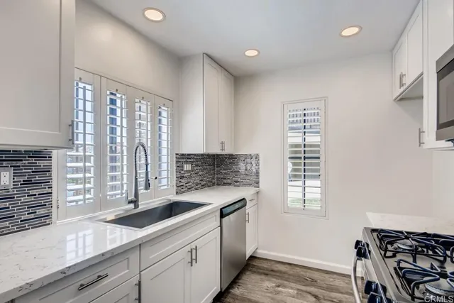 a kitchen that has a sink and a stove