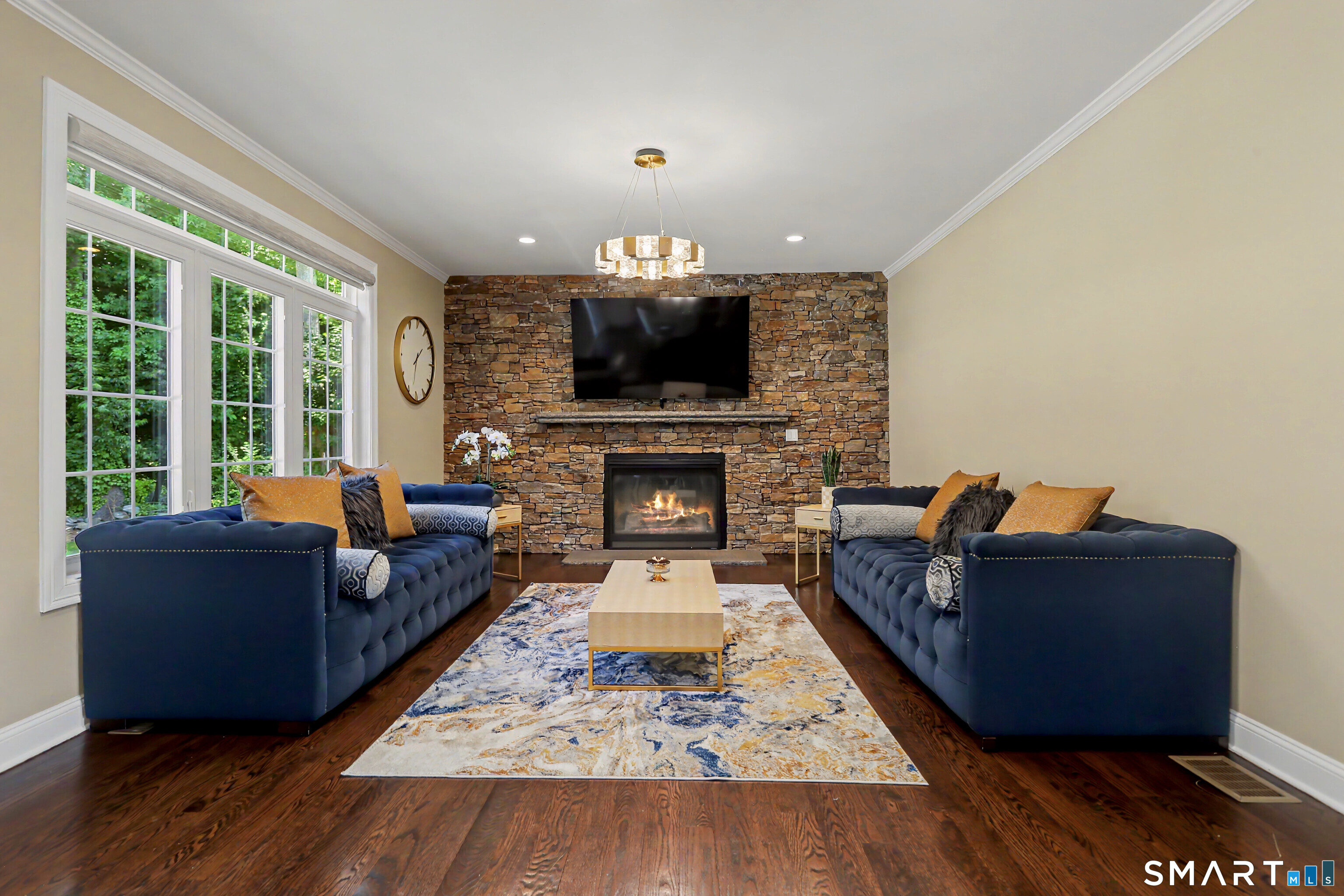 73 Candlewood Road Orange, CT 06477 - Photo 16 of 39 Ledgestone Accent wall in living room with gas fireplace