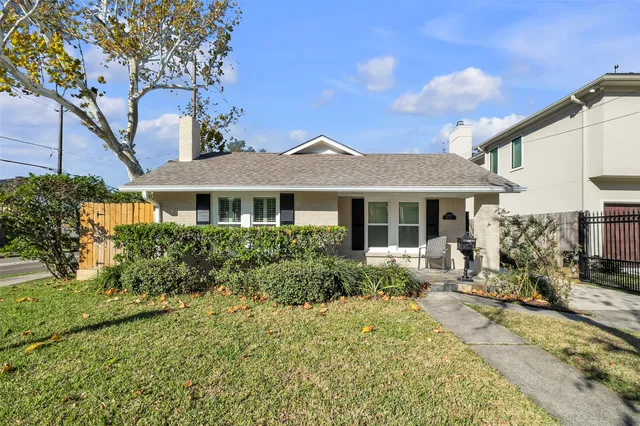 a front view of a house with yard outdoor seating and barbeque oven
