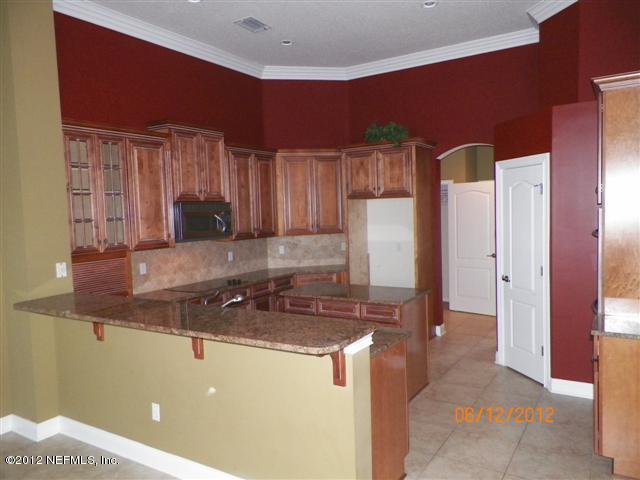 2000 River's Own Road St. Augustine, FL 32092 - Photo 11 of 36 a kitchen with stainless steel appliances granite countertop a sink and a refrigerator