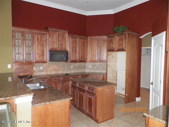 2000 River's Own Road St. Augustine, FL 32092 - Photo 12 of 36 a kitchen with stainless steel appliances granite countertop a sink stove and refrigerator