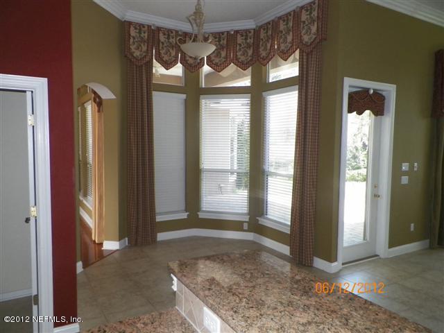 2000 River's Own Road St. Augustine, FL 32092 - Photo 14 of 36 a view of an empty room with a fireplace and a window