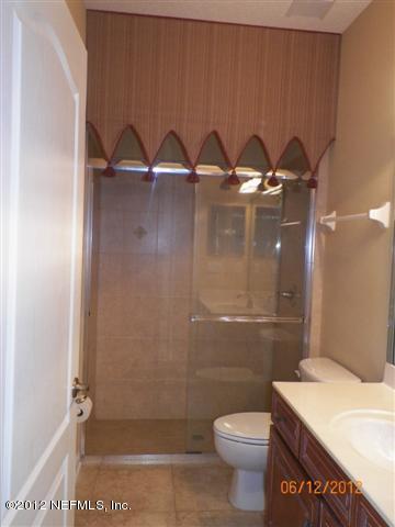 2000 River's Own Road St. Augustine, FL 32092 - Photo 29 of 36 a bathroom with a granite countertop sink toilet and a shower