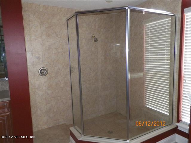2000 River's Own Road St. Augustine, FL 32092 - Photo 10 of 36 a bathroom with a glass shower door