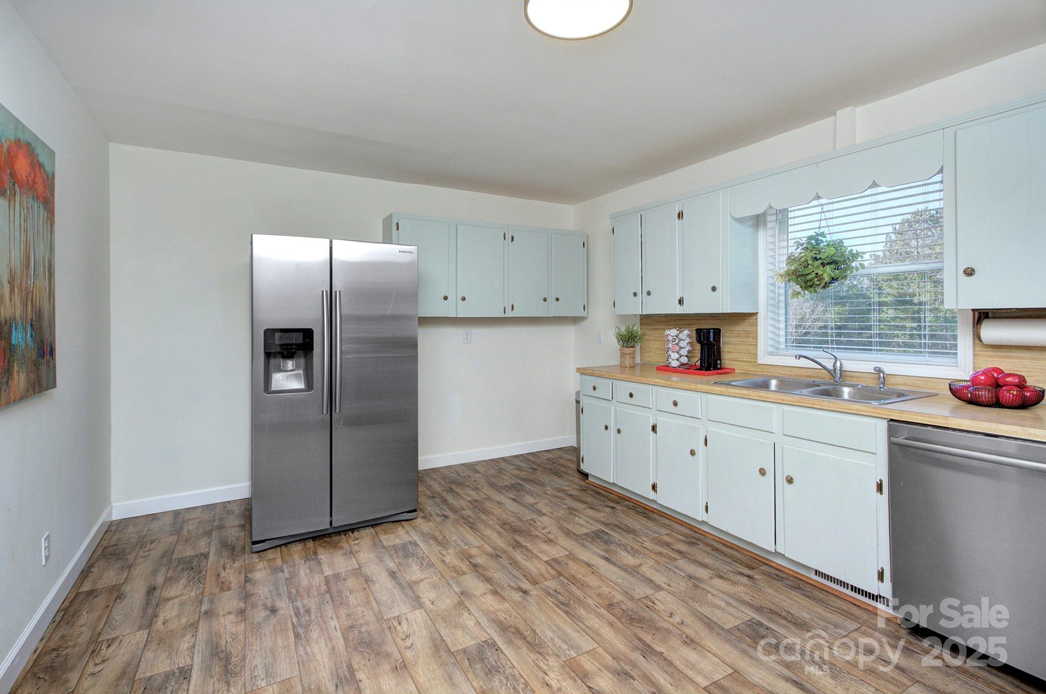 1615 Deer Run Road Catawba, SC 29704 - Photo 11 of 31 a kitchen with granite countertop a refrigerator sink and cabinets