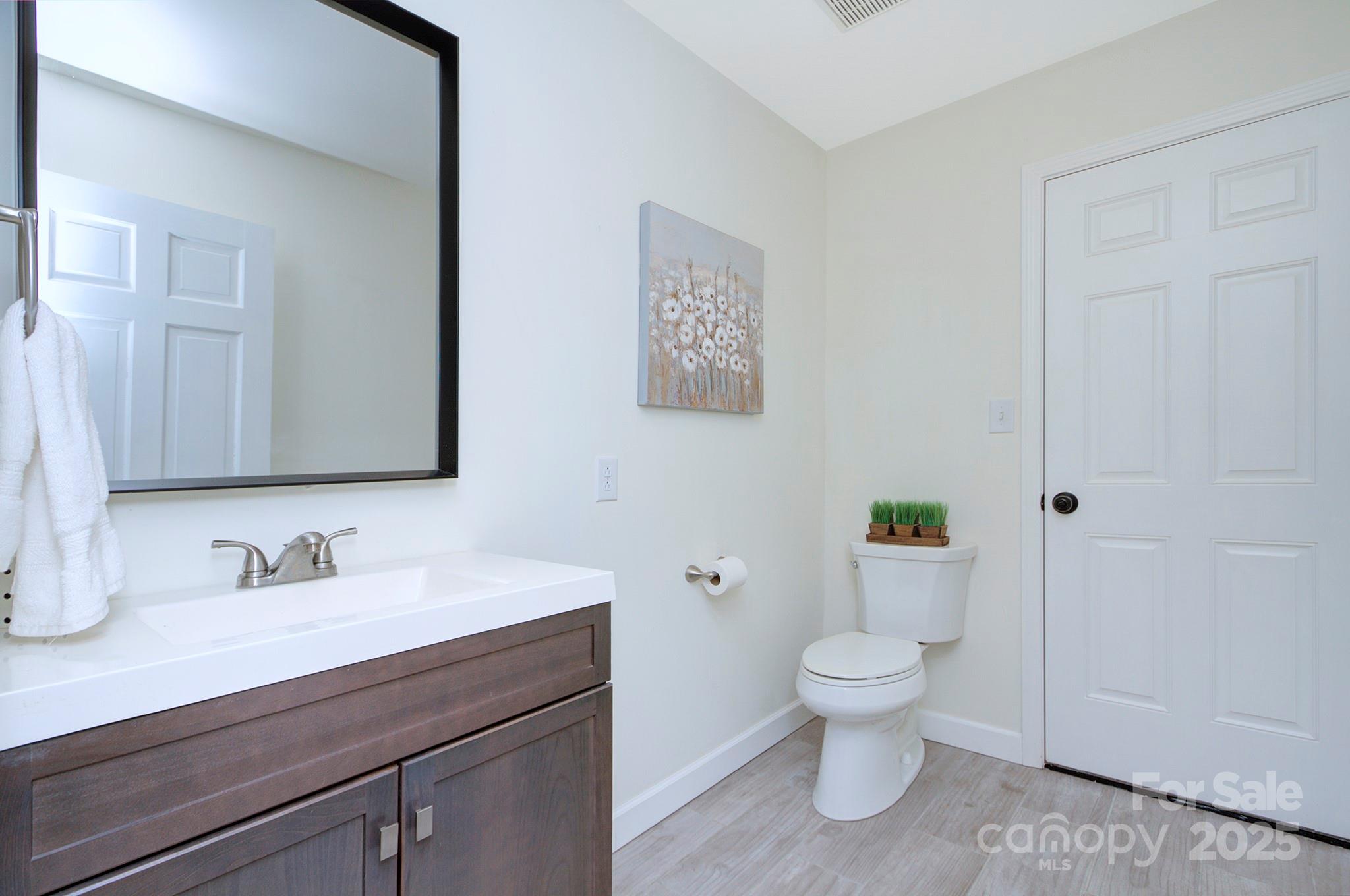 1615 Deer Run Road Catawba, SC 29704 - Photo 25 of 31 a bathroom with a granite countertop sink a toilet and a mirror